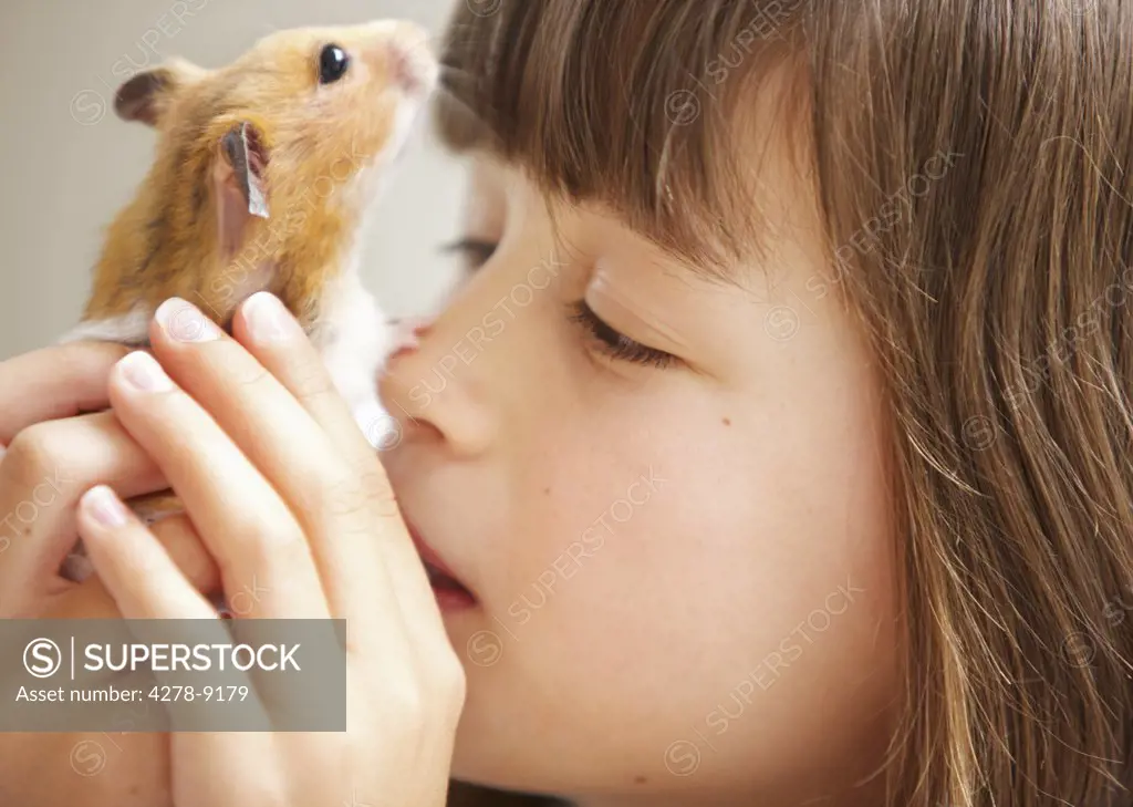 Girl Holding Hamster in front of Face