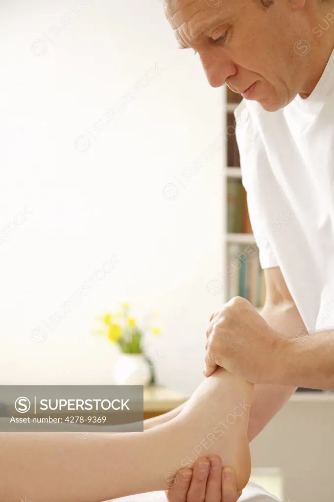 Osteopath Treating Woman's Foot