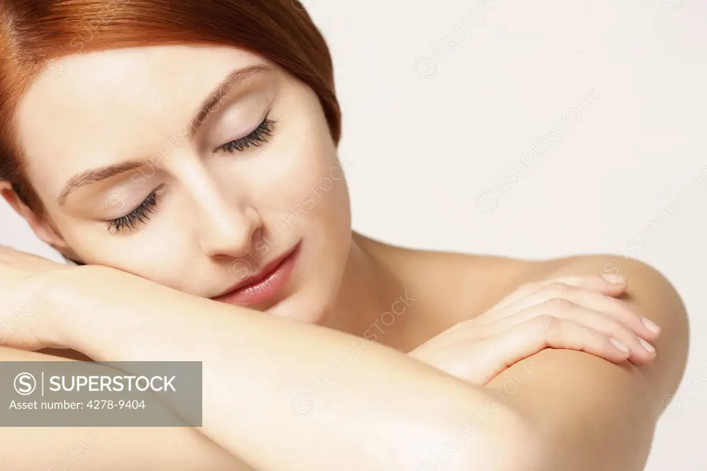 Woman with Face Resting on Arms