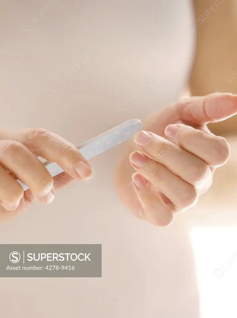 Woman Filing Fingernails, Close up view