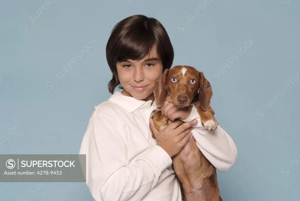 Boy Holding Dachshund in his Arms