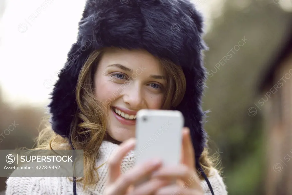 Teenage Girl Using Smartphone Outdoors
