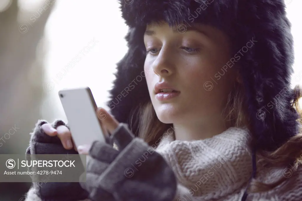 Teenage Girl Using Smartphone Outdoors