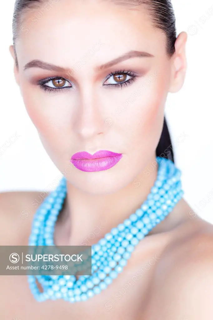Woman Wearing Purple Lipstick and Turquoise Beads Necklace