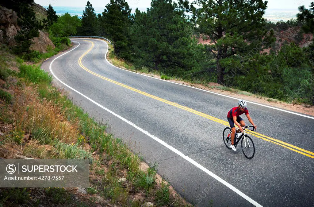 Cyclist Riding Bike on Road