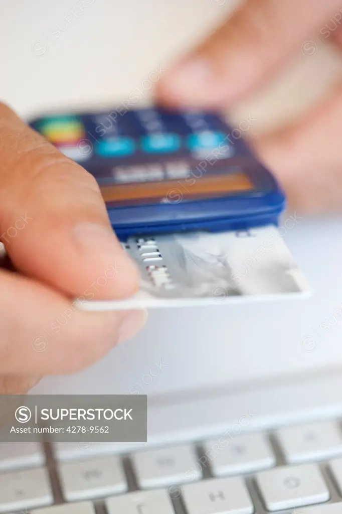 Man Inserting Credit Card into a Card Reader