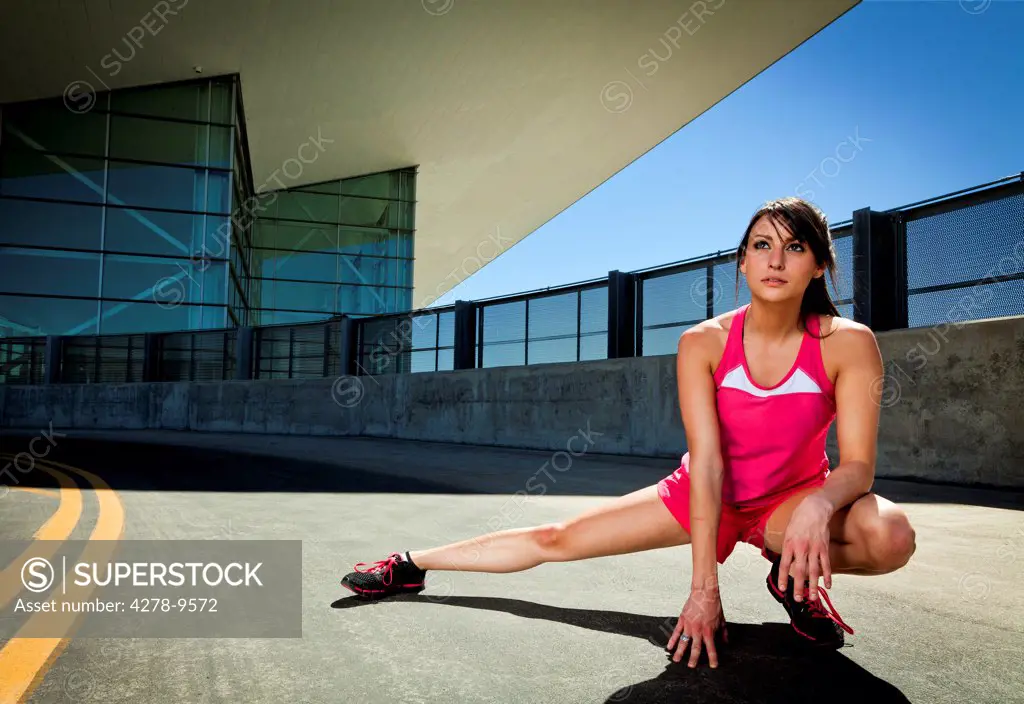 Young Woman Stretching Outdoors