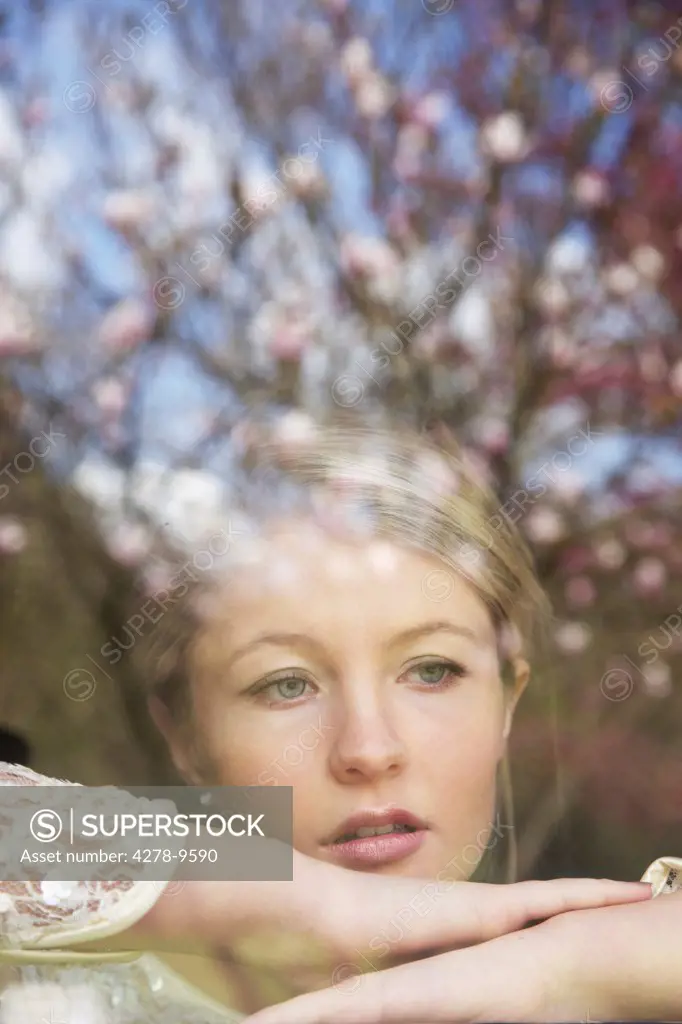 Young Woman Behind Window Pane