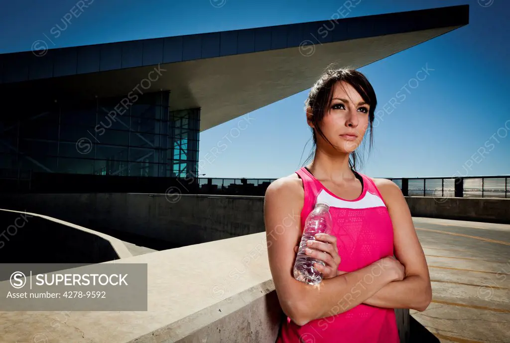 Young Woman in Sportswear with Bottle of Water