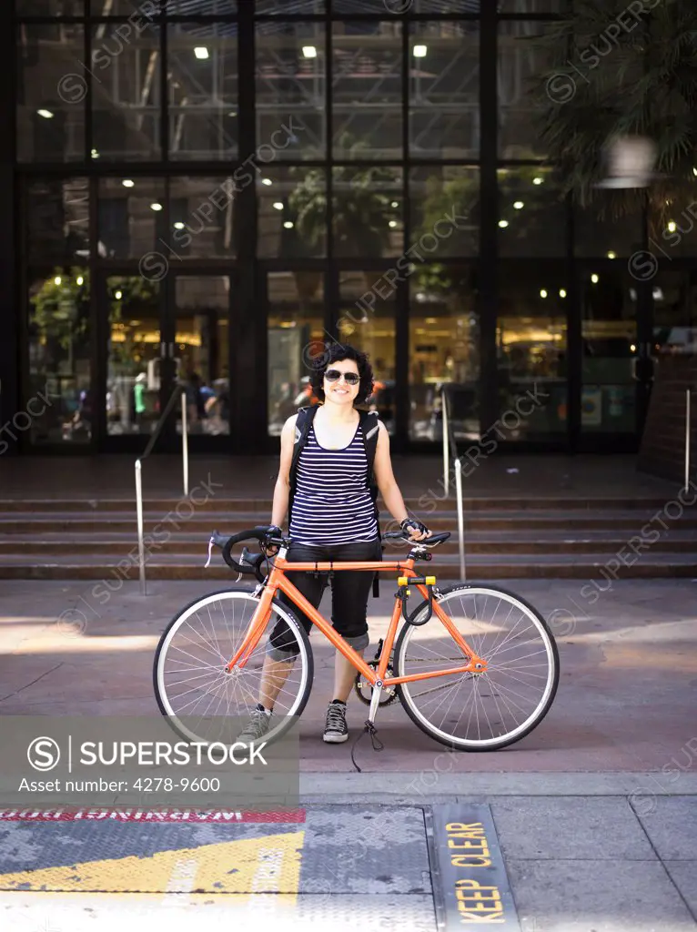 Woman with Bicycle in front of Office Building