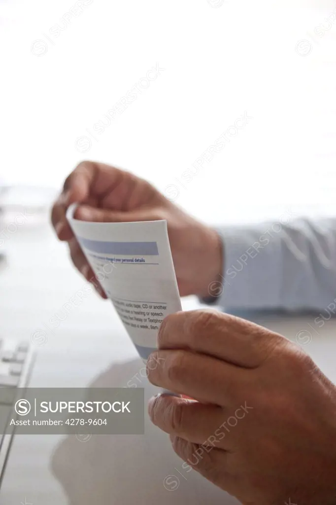 Man's Hands Holding Document