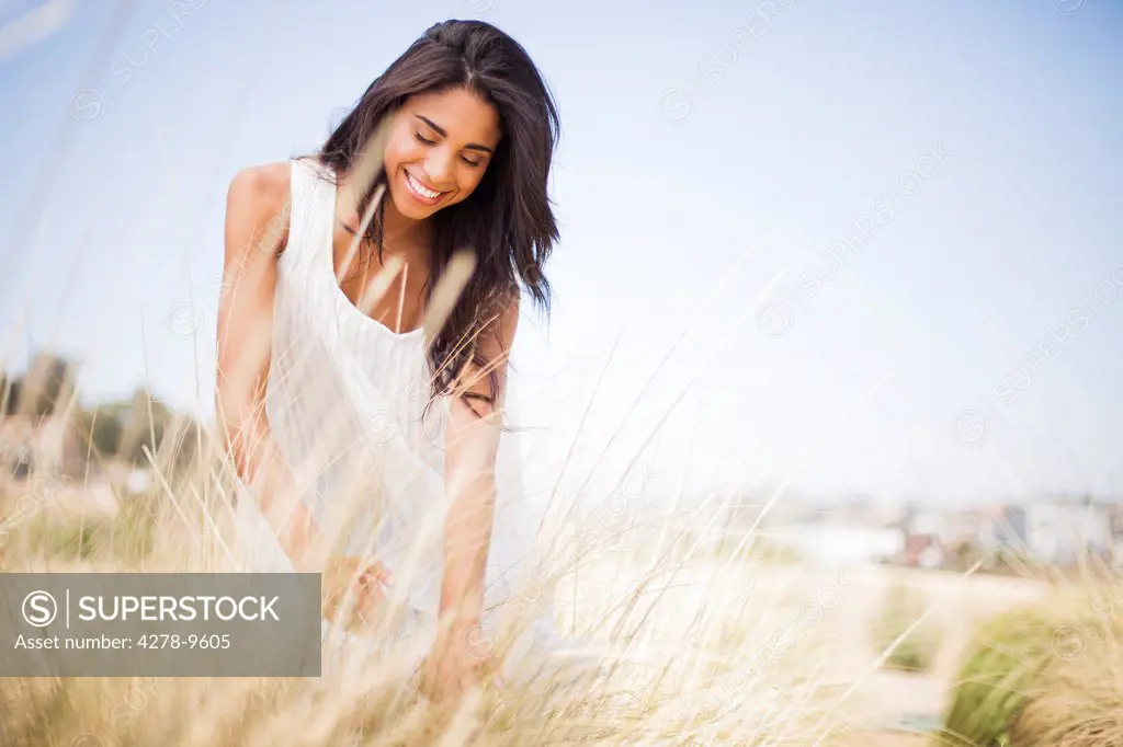 Smiling Woman in a Field of Tall Grass