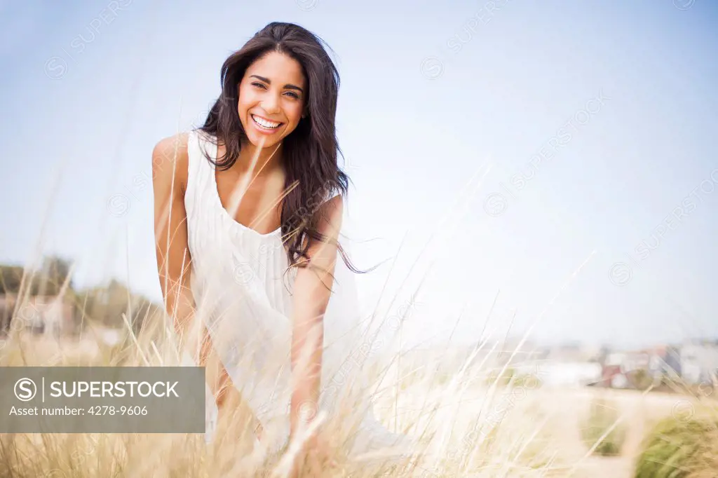 Smiling Woman in a Field of Tall Grass