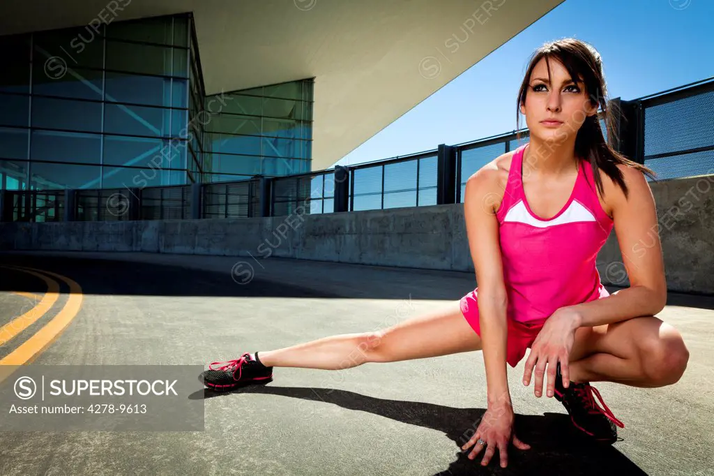 Young Woman Stretching Outdoors