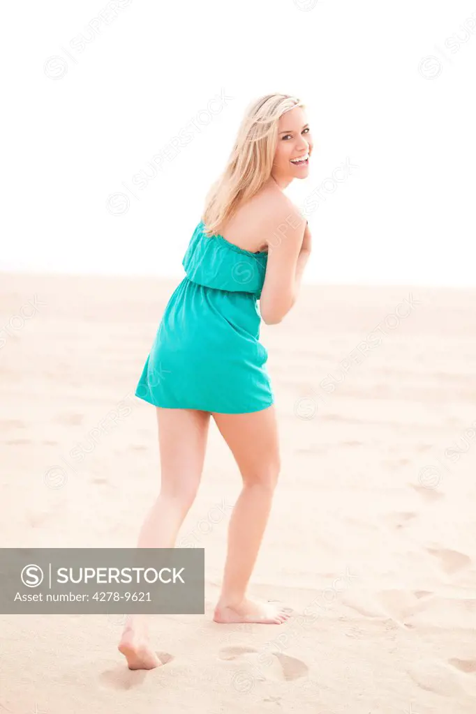 Smiling Woman Walking on Beach