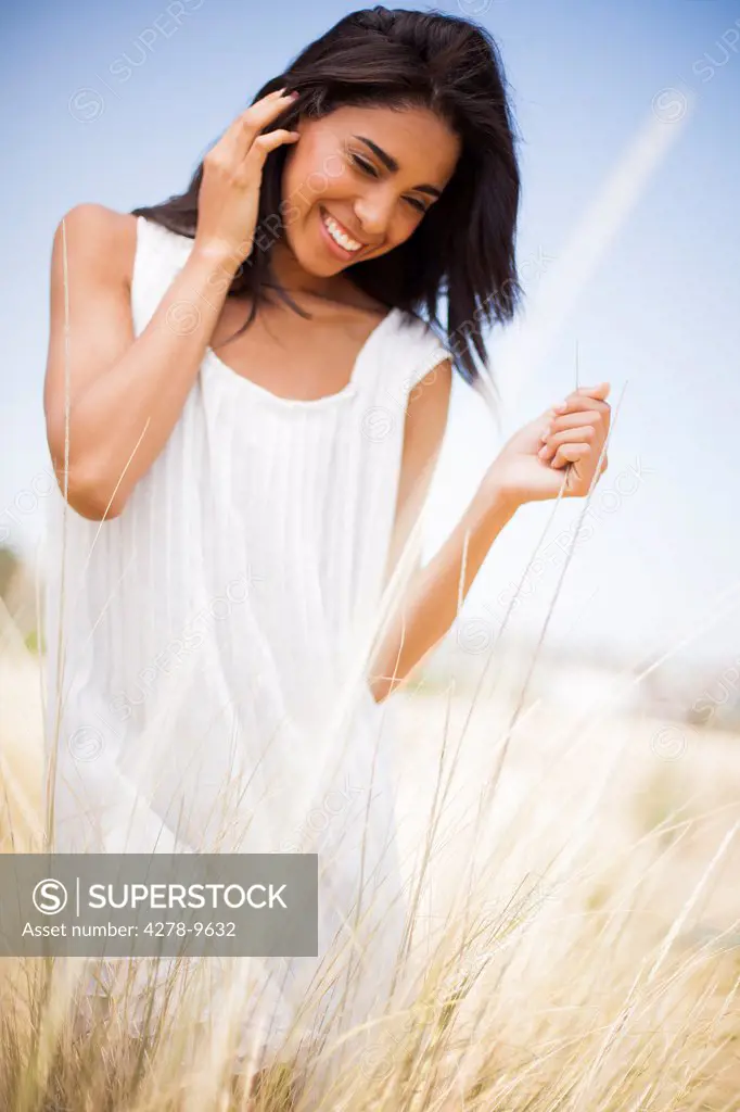 Smiling Woman in a Field of Tall Grass