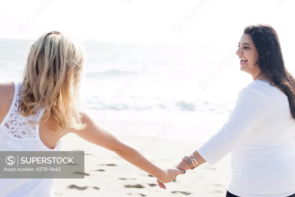 Two Women Holding Hands on a Beach