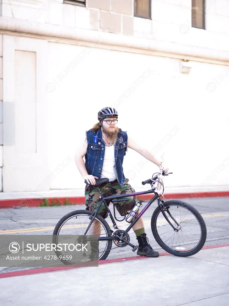 Man with Bicycle in City Street
