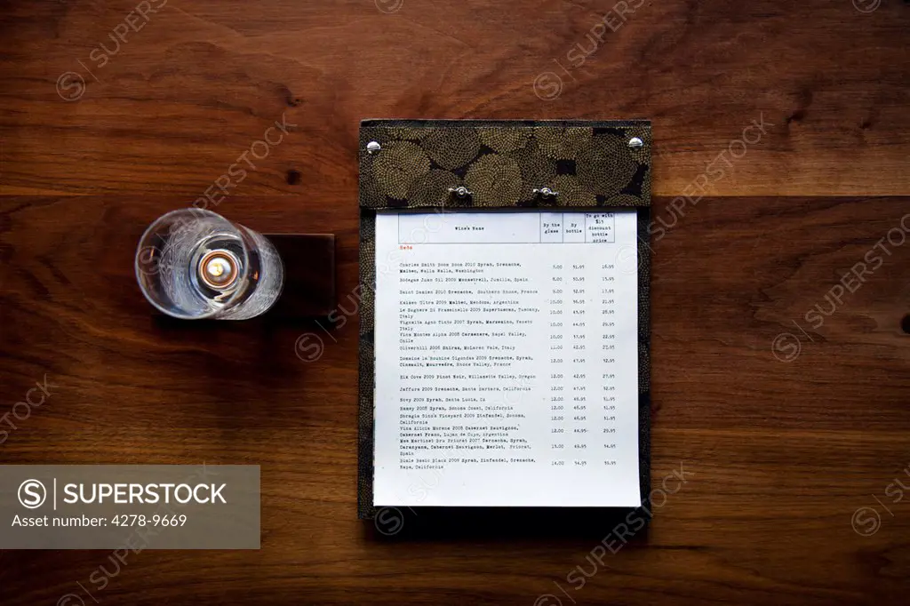Menu and Candleholder on Wooden Table