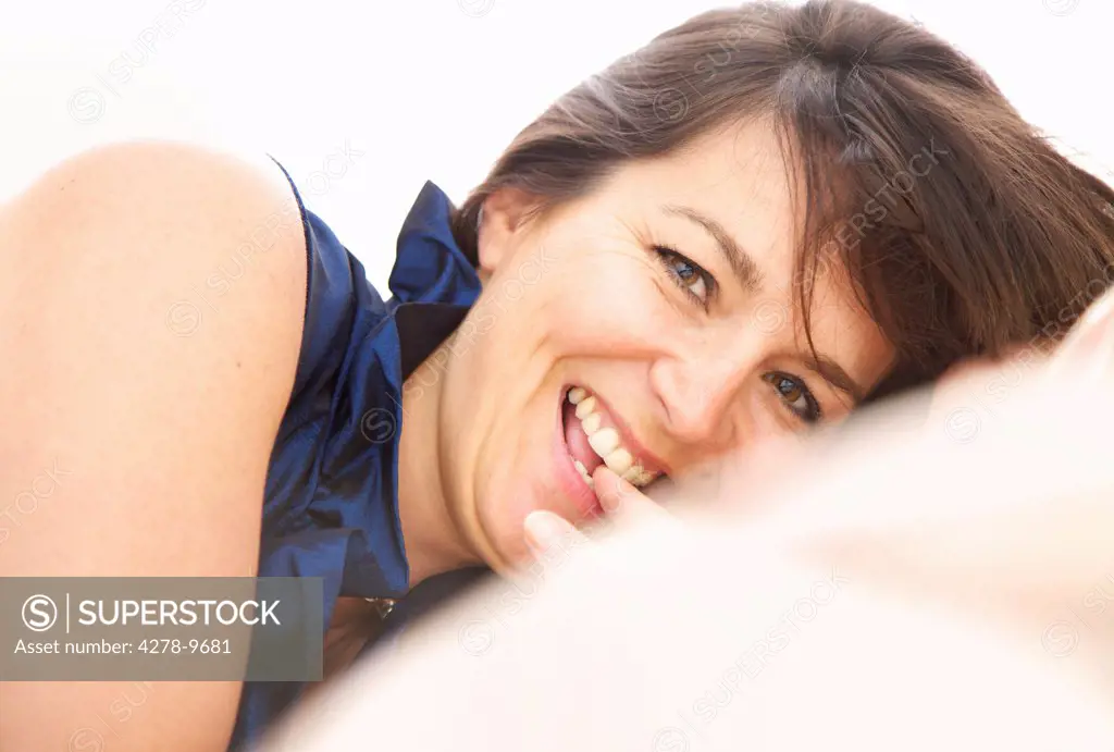 Smiling Woman Biting her Finger