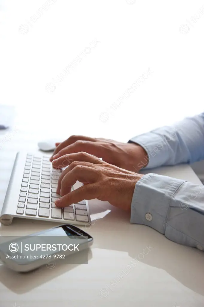 Man's Hands Typing on Keyboard