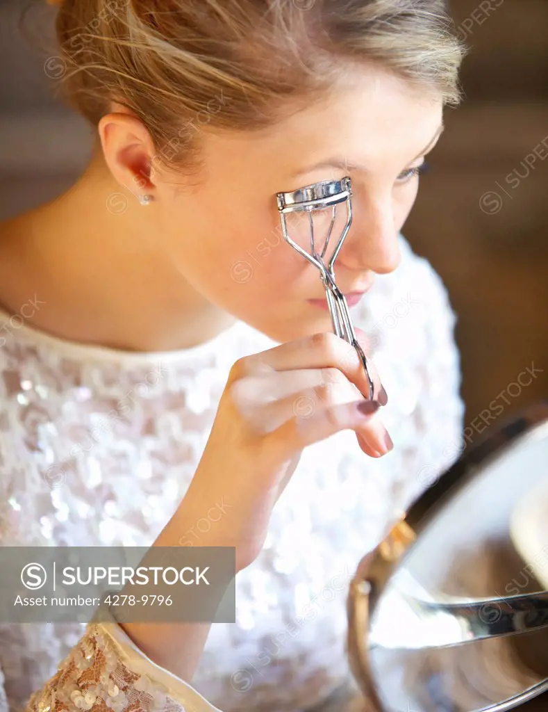 Young Woman Using Eyelash Curler
