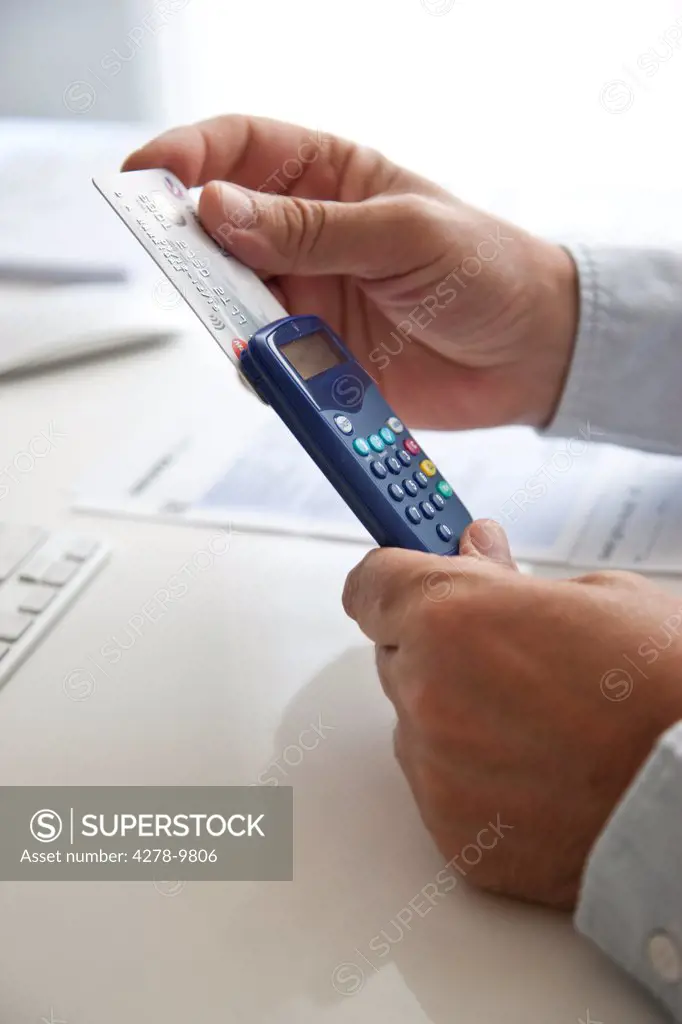 Man's Hands Inserting Credit Card into a Card Reader
