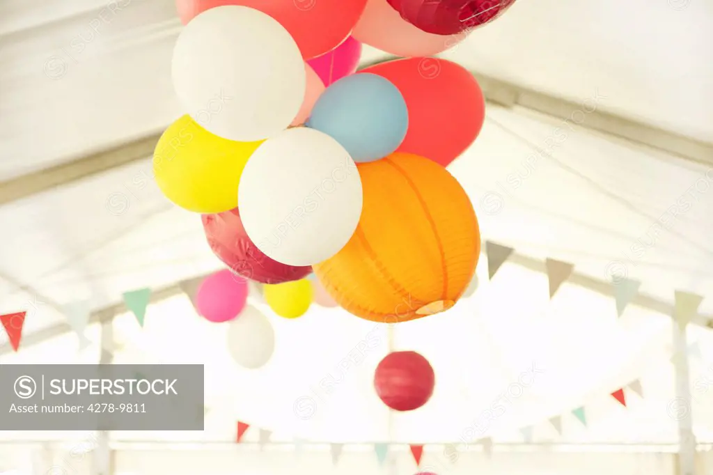 Paper Lanterns and Party Balloons Floating Inside a Marquee