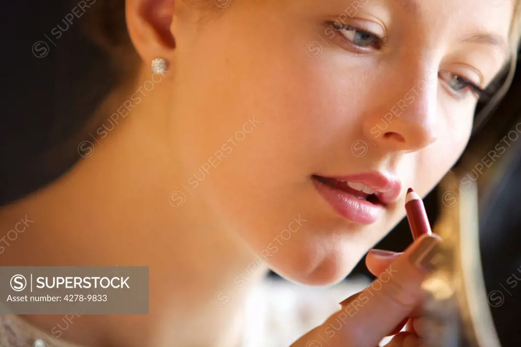 Close up of Young Woman Using Lip Pencil