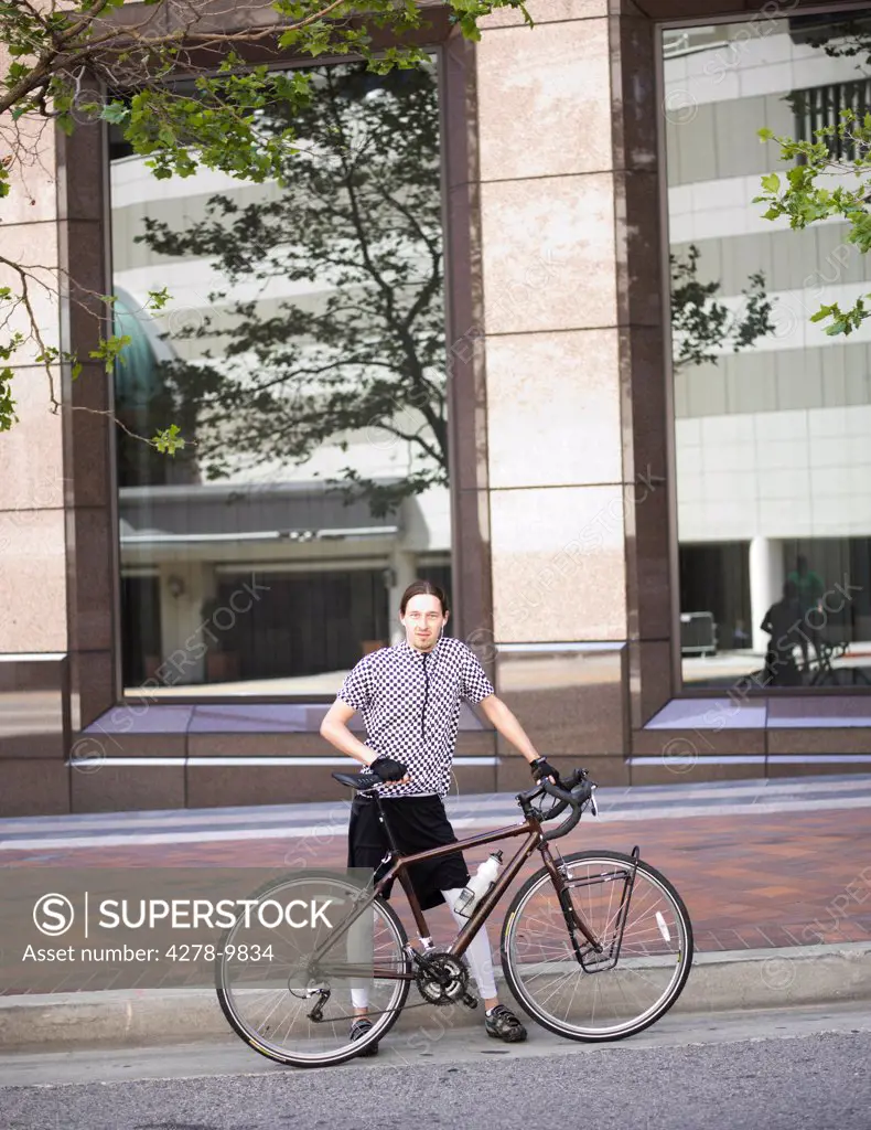Man with Bicycle in front of Office Building