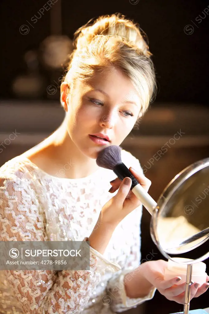 Young Woman Applying Blush