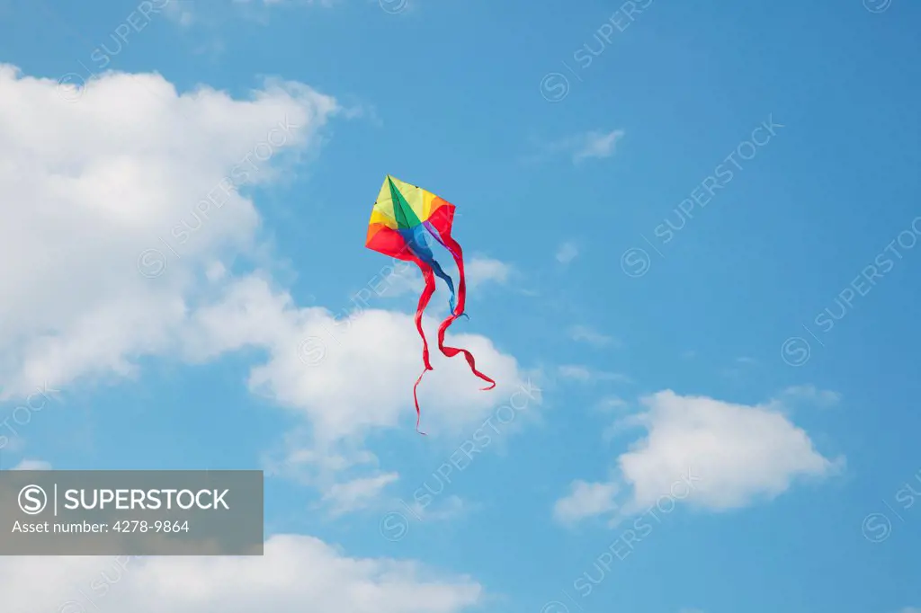 A Kite Flying in a Cloudy Blue Sky