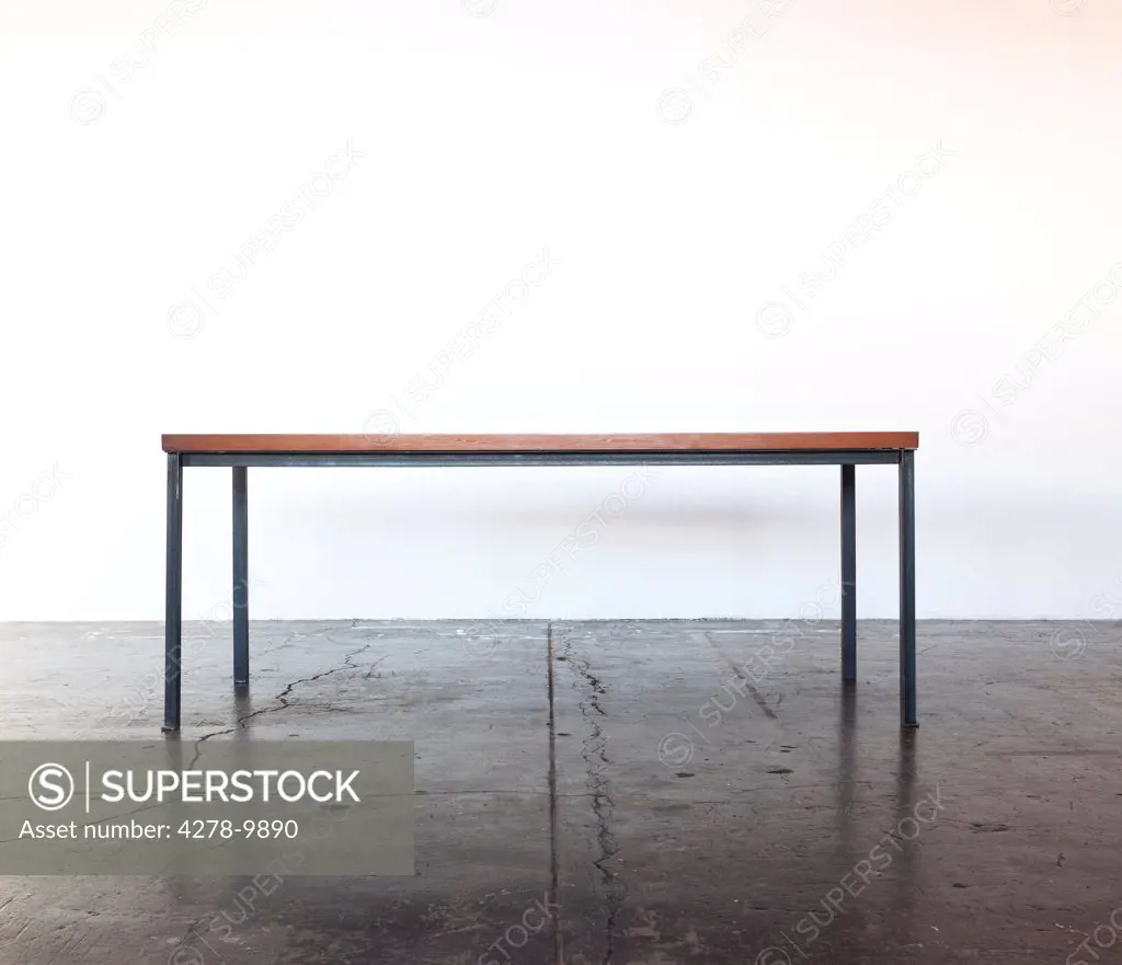 Iron Frame Wooden Table on Concrete Floor