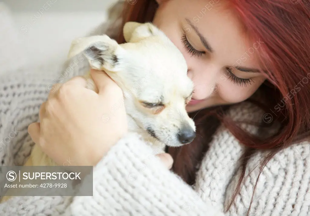 Teenage Girl Hugging a Chihuahua Dog