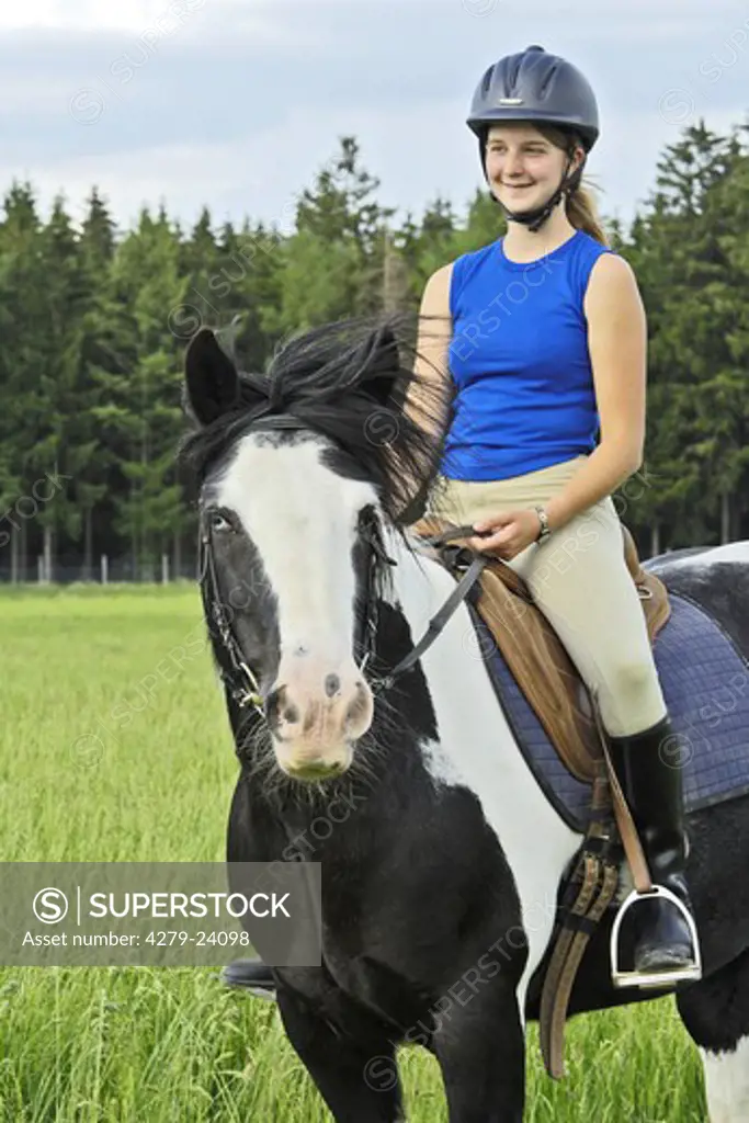 Girl riding on back of a Irish Tinker horse