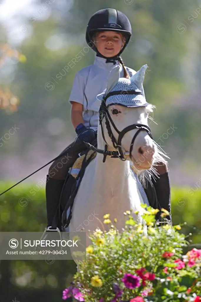 girl riding on German Riding Pony