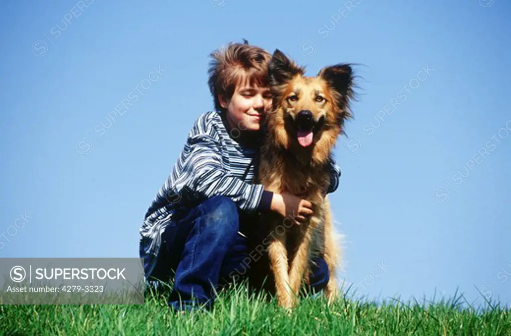 boy cuddling with dog