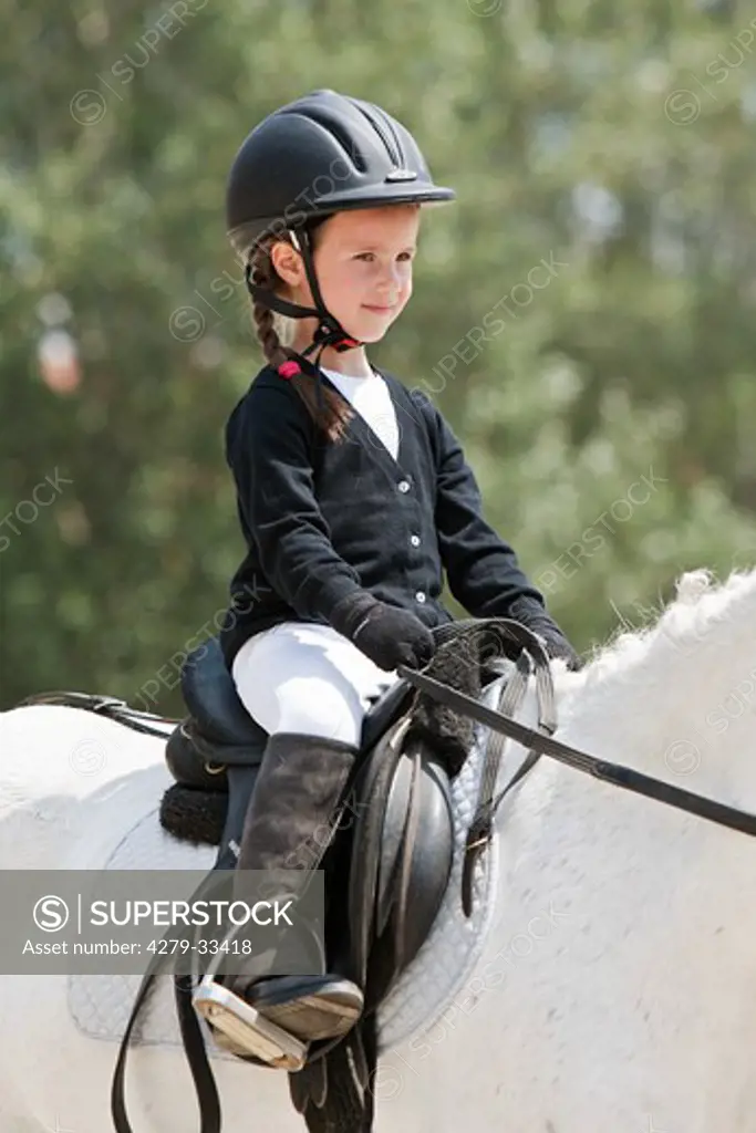 riding lesson: small girl on a horse