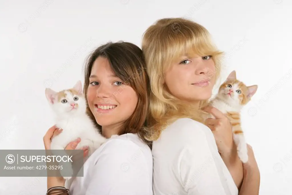 two girls with kittens