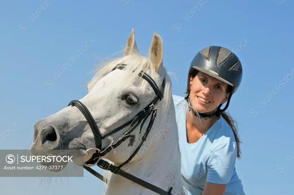 young woman riding on Bavarian warmblood horse