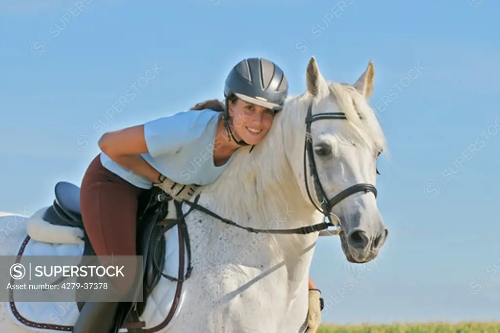 young woman riding on Bavarian warmblood horse