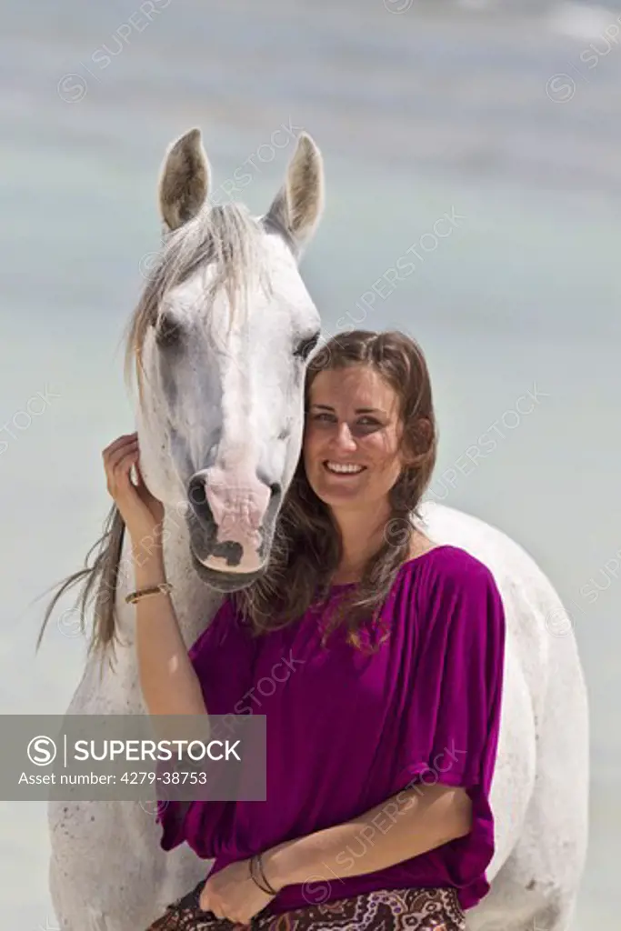 Arabian horse and young woman