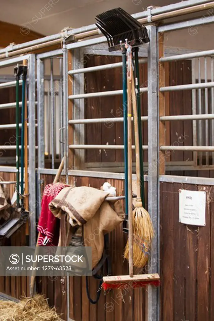 Tools for work in a stable hanging on the outside of a box