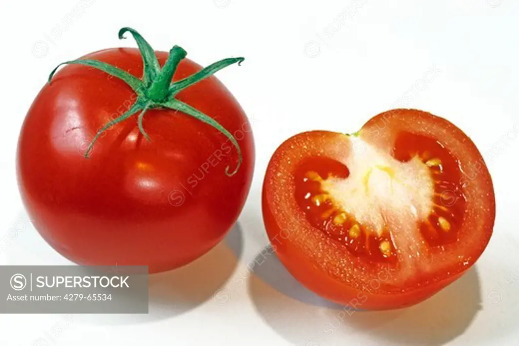 DEU, 2006: Tomato (Lycopersicon esculentum), whole and half fruit, studio picture.