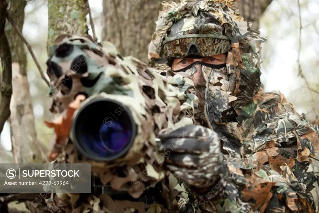 German nature documentary maker Hans Schweiger at work, well camouflaged. Oklahoma, USA