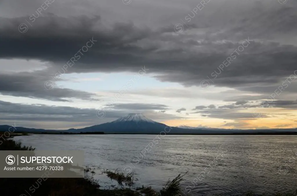 Lower Kronotskaya River with Kronotsky Volcano at sunset. Kamchatka, Russia