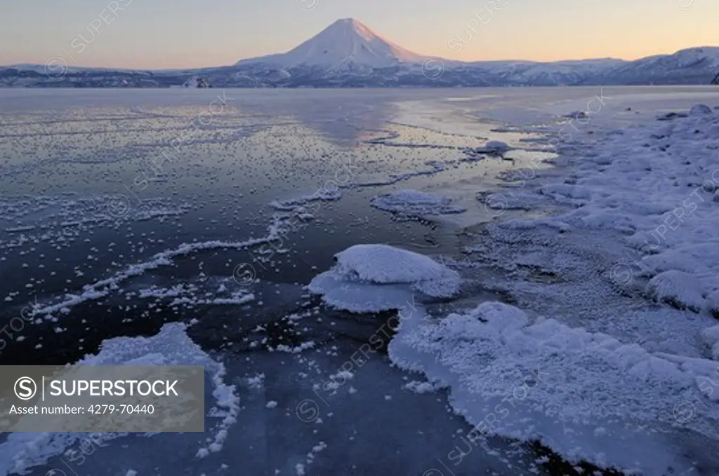 Frozen Kuril Lake with Ilinsky Volcano rising in the backdrop. Southern Kamchatka Wildlife Refuge, Kamchatka, Russia