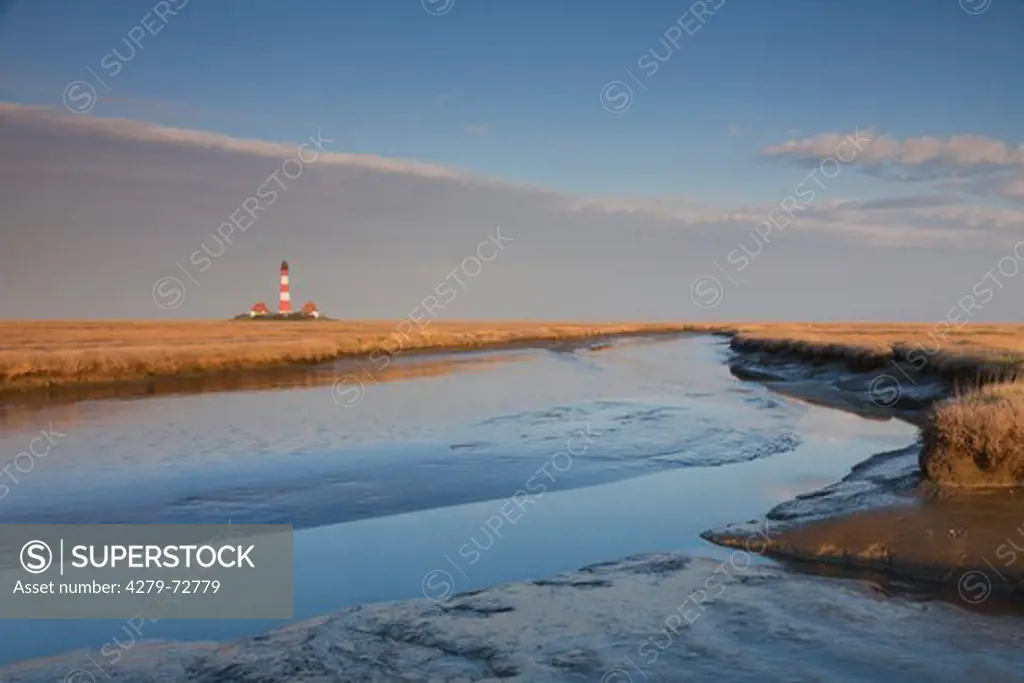 The lighthouse Westerheversand surrounded by salt marsh. Peninsula of Eiderstedt, North Frisia, Germany