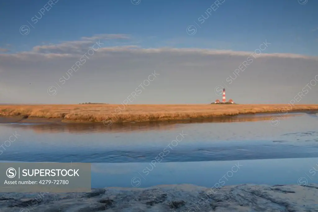 The lighthouse Westerheversand surrounded by salt marsh. Peninsula of Eiderstedt, North Frisia, Germany