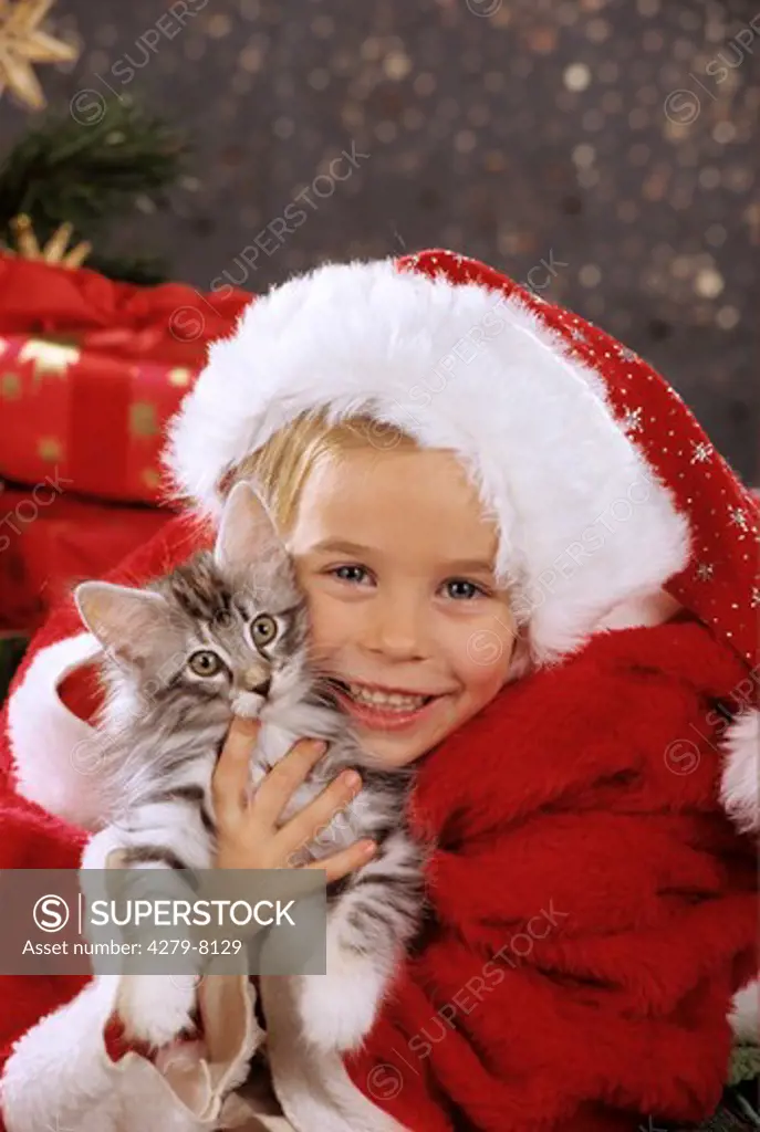 girl with Santa Claus cap and kitten
